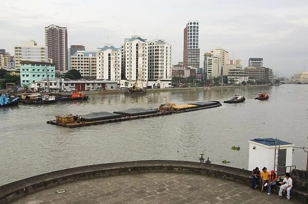Barge on River Pasig with city skyline behind