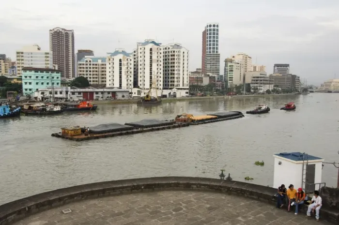 Framed Print : Barge on River Pasig with city skyline behind Framed Print : Barge on River Pasig with city skyline behind