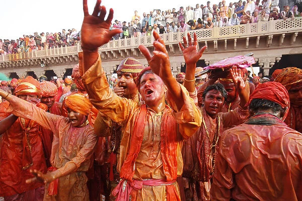 Barsana villagers celebrating Holi in Nandgaon, taunting Nandgaon villagers who throw