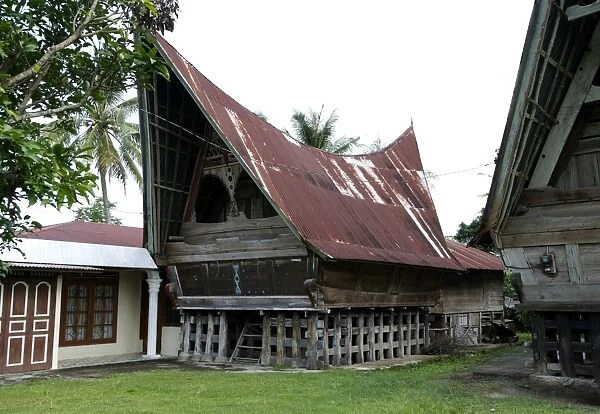 Batak Toba tribal rural village houses with contemporary extensions on Samosir Island in Lake Toba, Sumatra, Indonesia, Southeast Asia, Asia