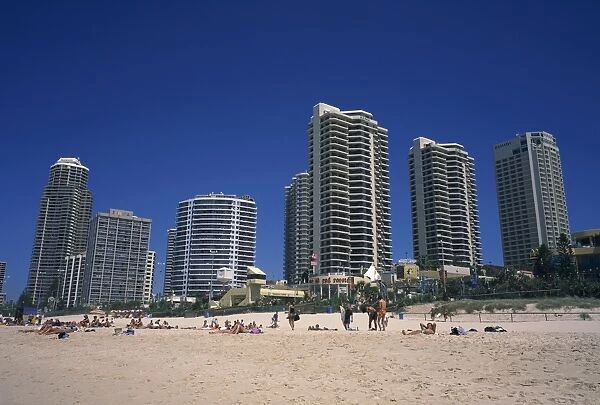 The beach, central shopping mall and restaurants, with skyline of apartment blocks behind