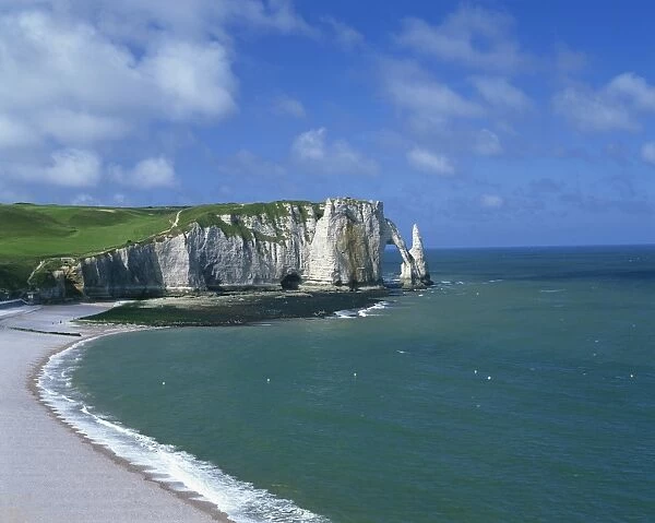 Beach, cliffs and rock arch, known as the Falaises, on the coast near Etretat
