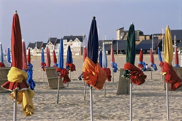 Beach and rolled up umbrellas, Deauville, Basse Normandie (Normandy), France, Europe