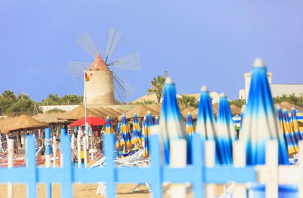 Beach umbrellas and windmill, Baia dei Mulini, Trapani, Sicily, Italy, Mediterranean