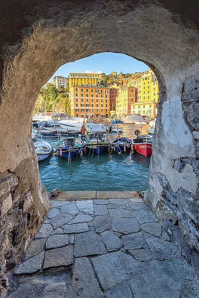 The beautiful harbour of Camogli seen through a house arch, Camogli, Genova province, Liguria, Italy, Europe