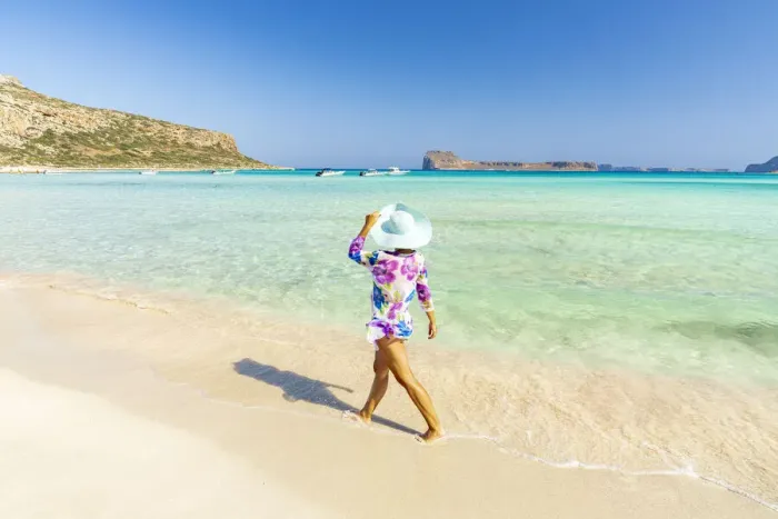 Framed Print : Beautiful woman with sun hat walking on idyllic empty beach, Crete, Greek Islands, Greece Framed Print : Beautiful woman with sun hat walking on idyllic empty beach, Crete, Greek Islands, Greece