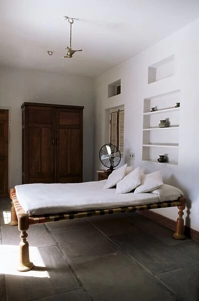 Bedroom with traditional low slung bed or charpoy in a home in Amber