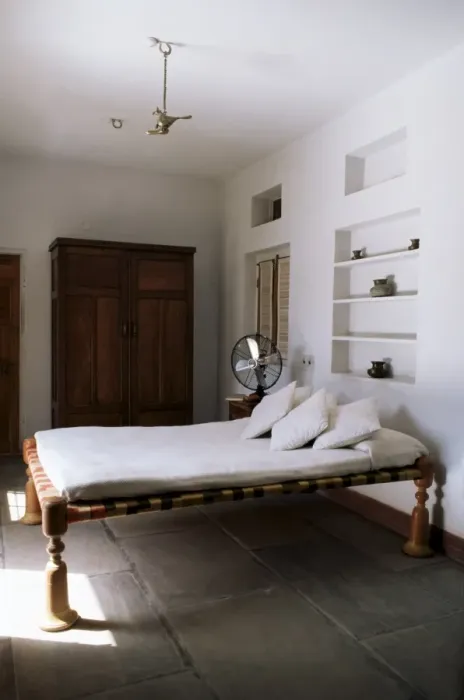 Framed Print : Bedroom with traditional low slung bed or charpoy in a home in Amber Framed Print : Bedroom with traditional low slung bed or charpoy in a home in Amber