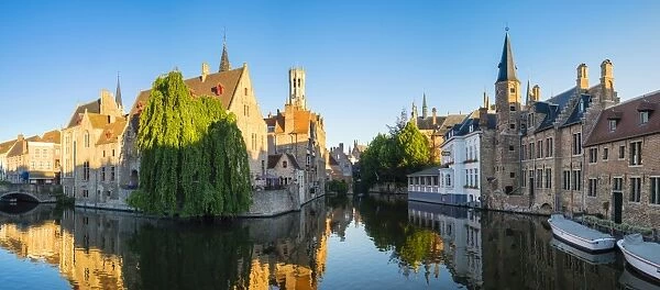 Belfort van Brugge and medieval buildings on the Dijver canal from Rozenhoedkaai at dawn