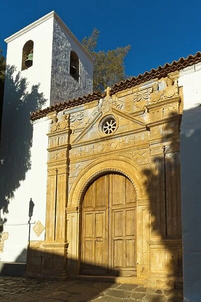 Bell tower and ornate doorway of the late 17th century Church of Nuestra Senora de la Regla, Pajara, Fuerteventura, Canary Islands, Spain, Atlantic, Europe