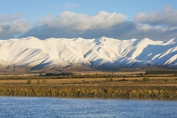 The Ben Ohau Range cloaked in autumn snow, the Pukaki Canal in foreground, Twizel