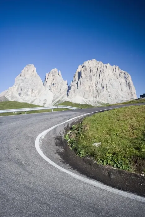Framed Print : A bend in a road passing the craggy peaks of the Sassolungo in the Dolomites Framed Print : A bend in a road passing the craggy peaks of the Sassolungo in the Dolomites