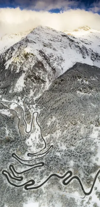 Framed Print : Bends of Maloja Pass road on snowy mountain ridge, aerial view, Bregaglia Valley Framed Print : Bends of Maloja Pass road on snowy mountain ridge, aerial view, Bregaglia Valley