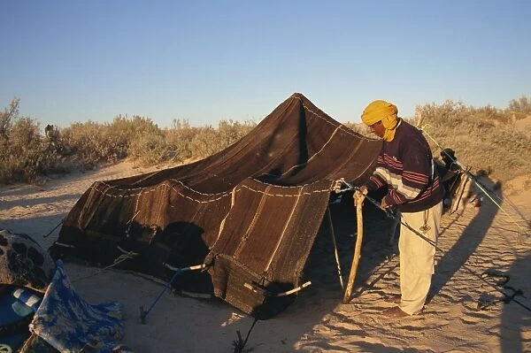 Berber guides erecting traditional tent