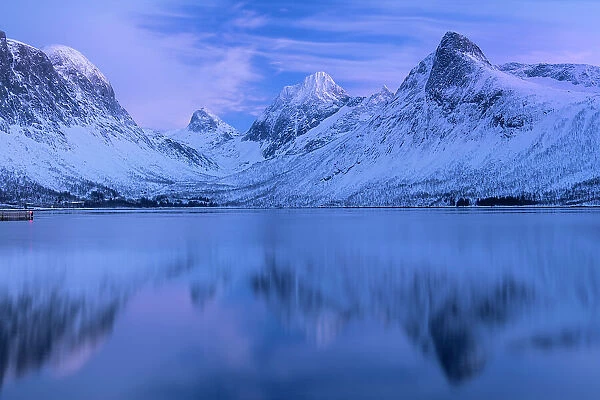 The Bergsbotn mountain range reflected in the waters of Bergsfjord, Bergsbotn, Senja, Troms og Finnmark county, Norway, Scandinavia, Europe