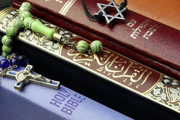 Bibles and Quran, interfaith symbols of Christianity, Islam and Judaism