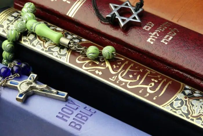 Framed Print : Bibles and Quran, interfaith symbols of Christianity, Islam and Judaism