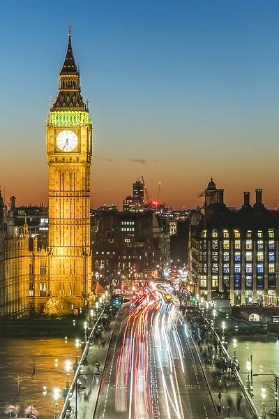 Big Ben (the Elizabeth Tower) and busy traffic on Westminster Bridge at dusk, London