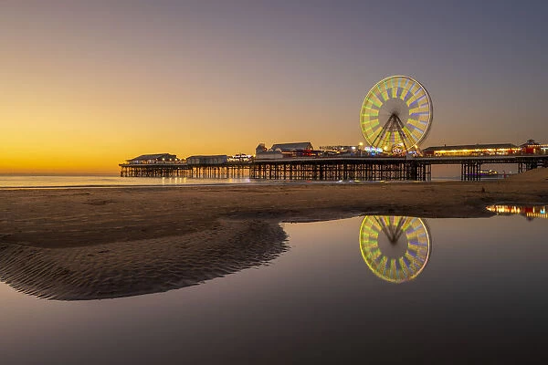 Big wheel and amusements on Central Pier at sunset, Blackpool, Lancashire, England