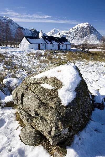 Black Rock Cottage with Buachaille Etive Mor in distance on snow covered Rannoch Moor