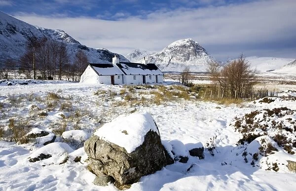 Black Rock Cottage with Buachaille Etive Mor in distance on snow covered Rannoch Moor