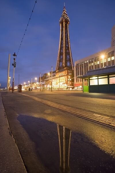 Blackpool Tower reflected in puddle at dusk, Blackpool, Lancashire, England