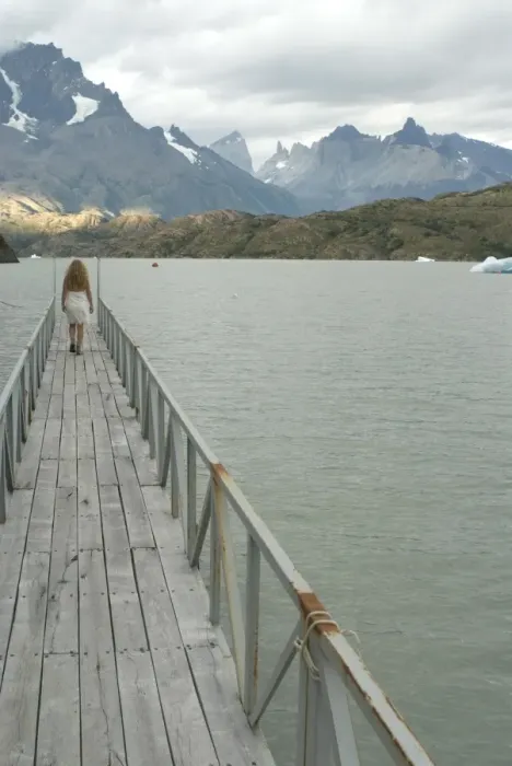 Framed Print : Blonde woman walks to the end of dock on Lago Grey, Torres del Paine, Chile Framed Print : Blonde woman walks to the end of dock on Lago Grey, Torres del Paine, Chile