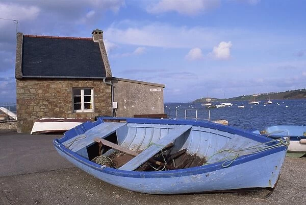 Blue boat on shore with the harbour of Le Fret behind, Brittany, France, Europe