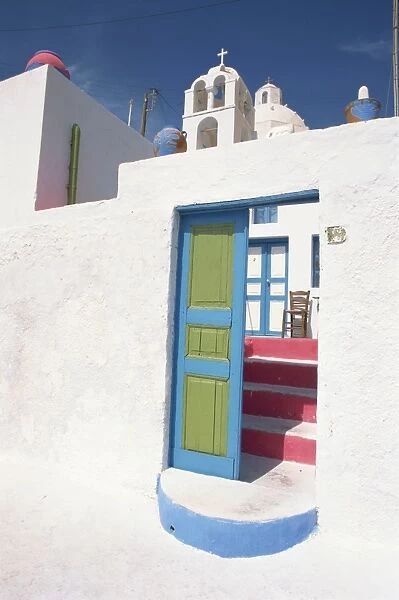 Blue and green door leading to pink steps at the entrance