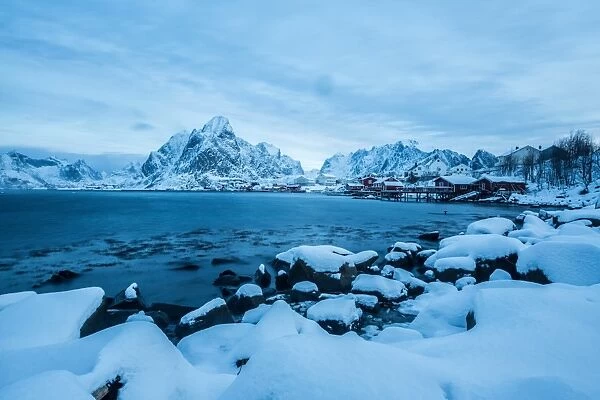 Blue hour in the bay of Reine, where for many months of the year the snow and cold force the residents to remain in their homes, Reine, Lofoten Islands, Arctic, Norway, Scandinavia, Europe
