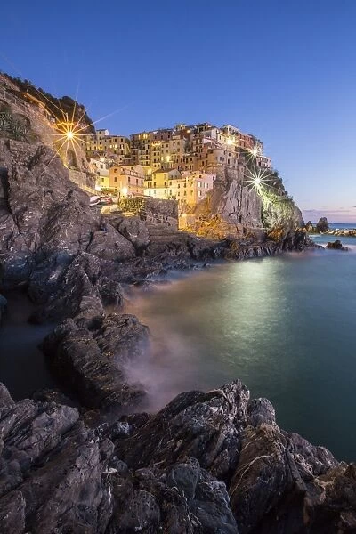 Blue hour in the little village of Manarola with its pastel coloured houses in the Cinque Terre National Park, UNESCO World Heritage Site, Liguria, Italy, Europe