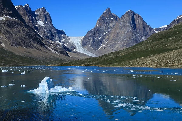 Blue iceberg, pyramidal peaks, glacier, rugged South Skjoldungen Fjord and Island