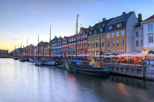Blue lights of dusk on harbour and canal of the entertainment district of Nyhavn
