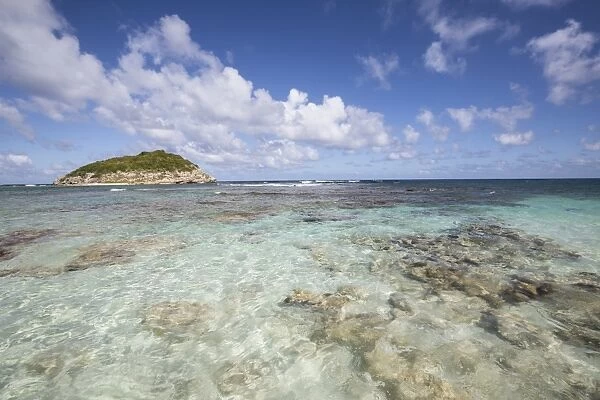 Blue sky and clouds frame the turquoise Caribbean Sea, Half Moon Bay, Antigua and Barbuda