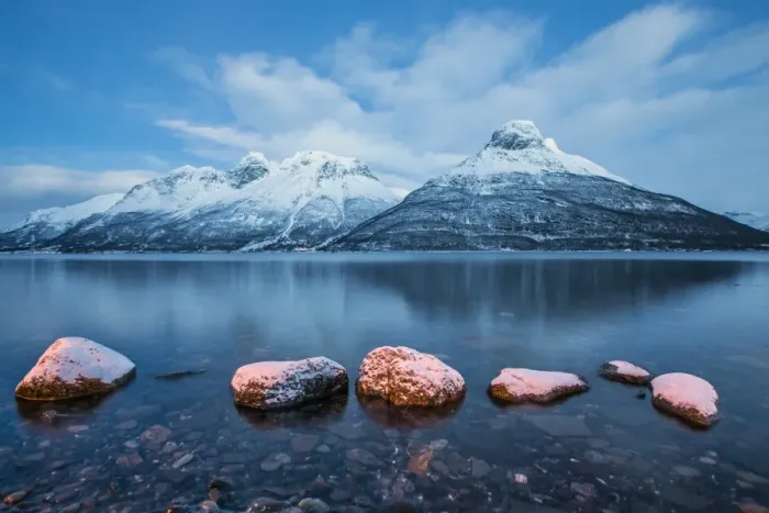 Framed Print : Blue sky at dusk and snowy peaks are reflected in the frozen sea, Storfjorden, Lapland
