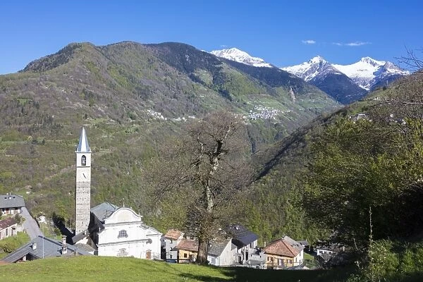 Blue sky frames the snowy peaks and the alpine village of Rasura, Orobie Alps, Gerola Valley
