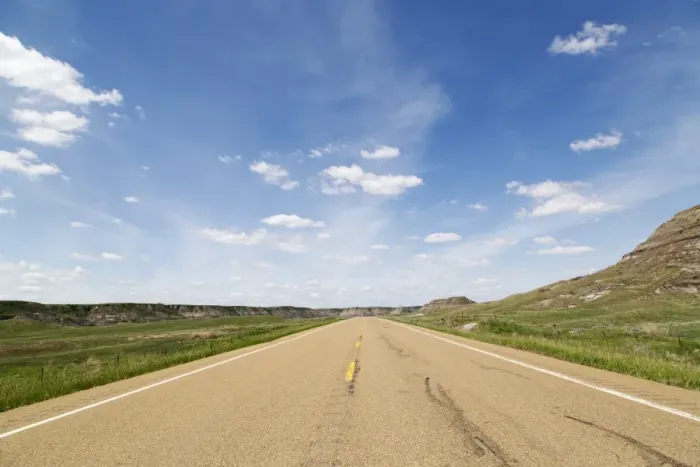 Framed Print : Blue sky over a highway through the Badlands of Alberta, near Drumheller, Alberta Framed Print : Blue sky over a highway through the Badlands of Alberta, near Drumheller, Alberta