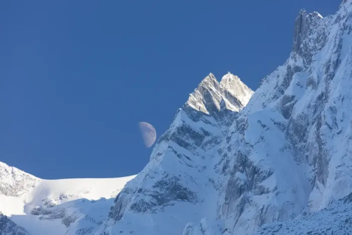 Framed Print : Blue sky and moon on the snowy ridges of the high peaks, Soglio, Bregaglia Valley