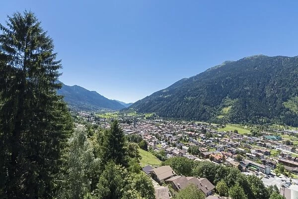 Blue sky and woods frame the alpine village of Pinzolo, Brenta Dolomites, Trentino-Alto Adige
