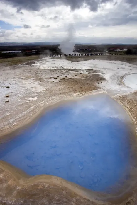 Framed Print : Blue water in geothermal pool with stream from Strokkur Geysir visible in the distance Framed Print : Blue water in geothermal pool with stream from Strokkur Geysir visible in the distance
