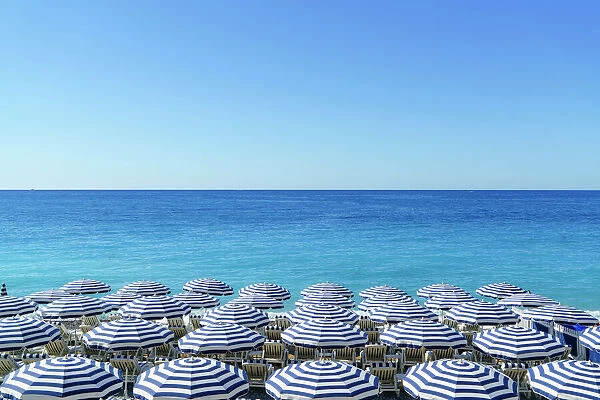 Blue and white beach parasols, Nice, Cote d Azur, Alpes-Maritimes, Provence, French Riviera