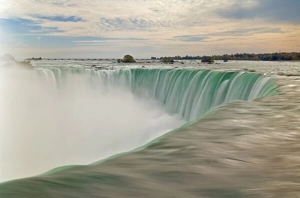 Blurry slow motion water at the top of the Horseshoe Falls waterfall on the Niagara River