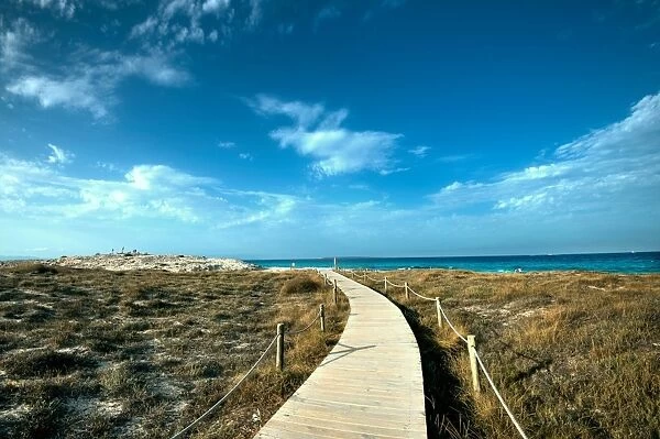 Boardwalk leading towards the horizon and Infinity Beach on Formentera, Balearic Islands