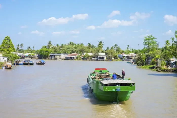 Framed Print : A boat on a branch of the Mekong River at Phong Dien, Can Tho, Mekong Delta, Vietnam