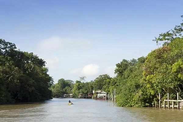A boat on an igarape (flooded creek) in the Brazilian Amazon near Belem, Para, Brazil