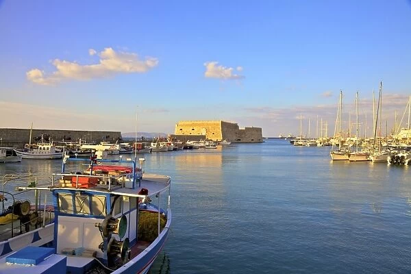 The boat lined Venetian Harbour and Fortress, Heraklion, Crete, Greek Islands, Greece