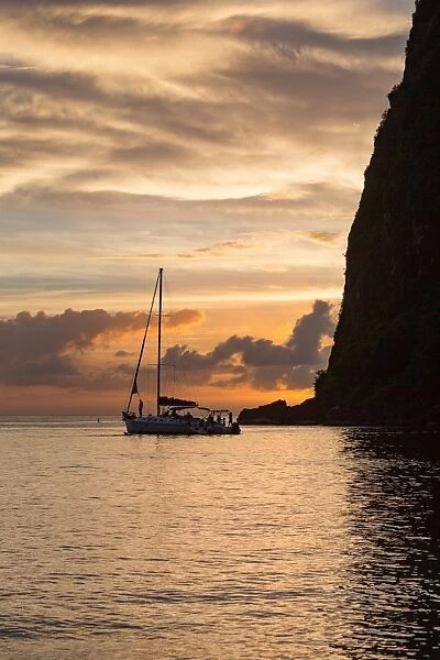 Boat moored at the base of Petit Piton near Sugar Beach at dusk, St. Lucia, Windward Islands