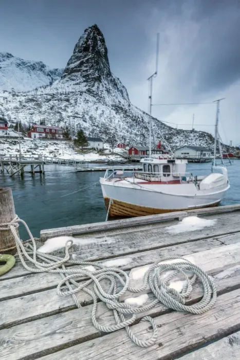 Framed Print : A boat moored in the cold sea in the background the snowy peaks, Reine. Lofoten Islands Framed Print : A boat moored in the cold sea in the background the snowy peaks, Reine. Lofoten Islands