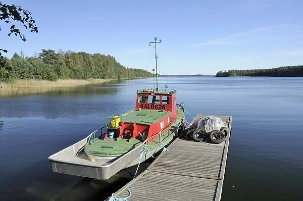 Boat moored at a jetty on Lake Puruvesi, a branch of Lake Saimaa near Kerimaki, Finland, Scandinavia, Europe