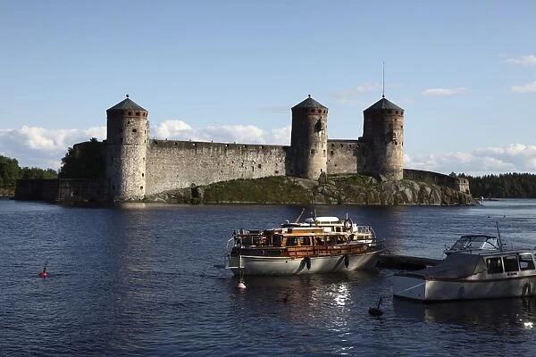 Boat moored in front of Olavinlinna Medieval Castle (St. Olafs Castle)